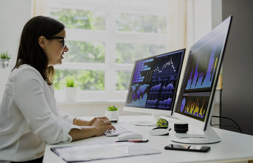 image of a technology worker analyzing data on a computer