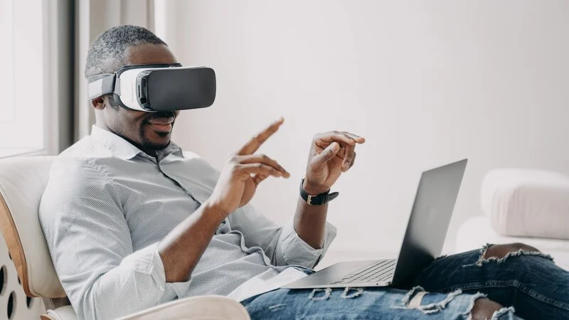black businessman wearing VR goggles